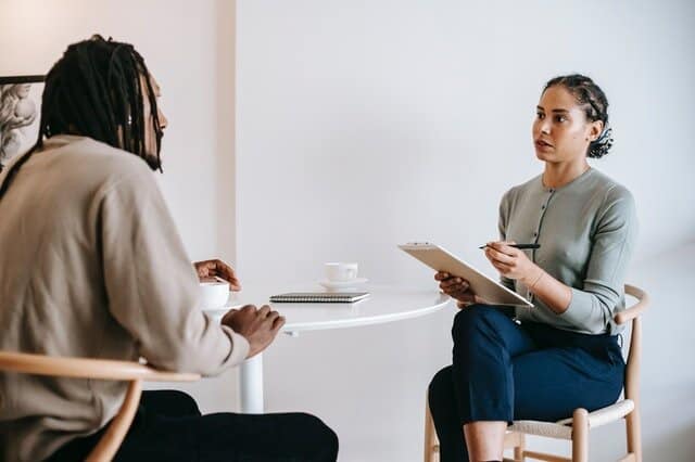 Ethnic female psychotherapist listening to black clients explanation Ethnic female psychotherapist listening to black clients explanation