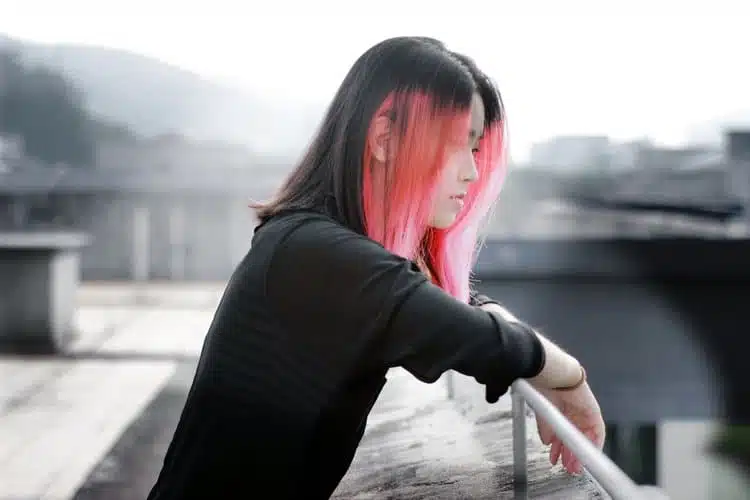 Bipolar teen looking out from a bridge