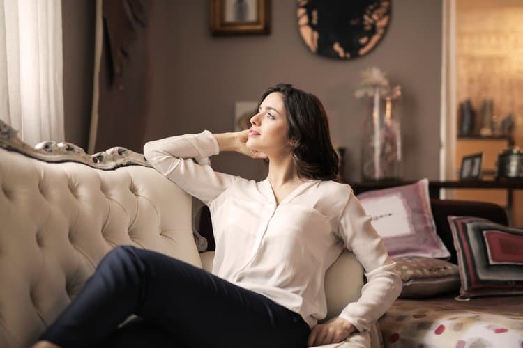 smiling woman relaxing on a sofa