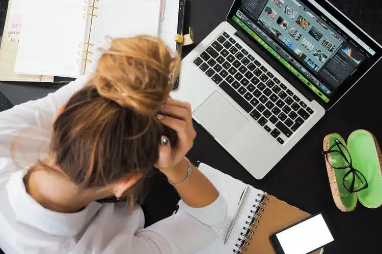 Stressed female college student working on her laptop