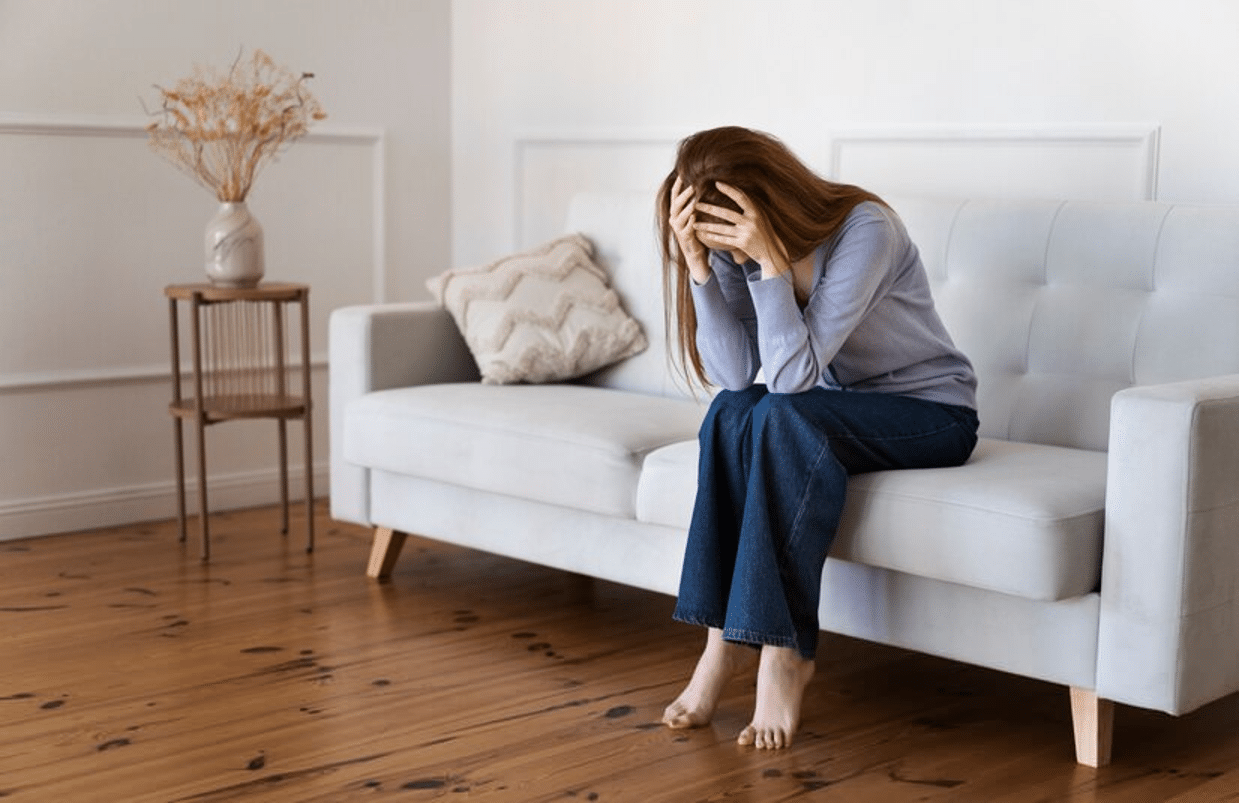 Sitting on a couch, frustrated