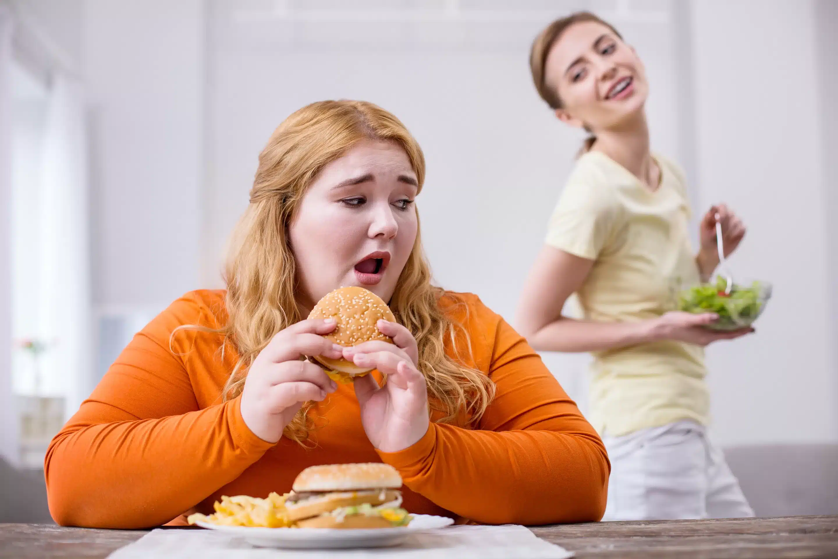 a woman eating a hamburger