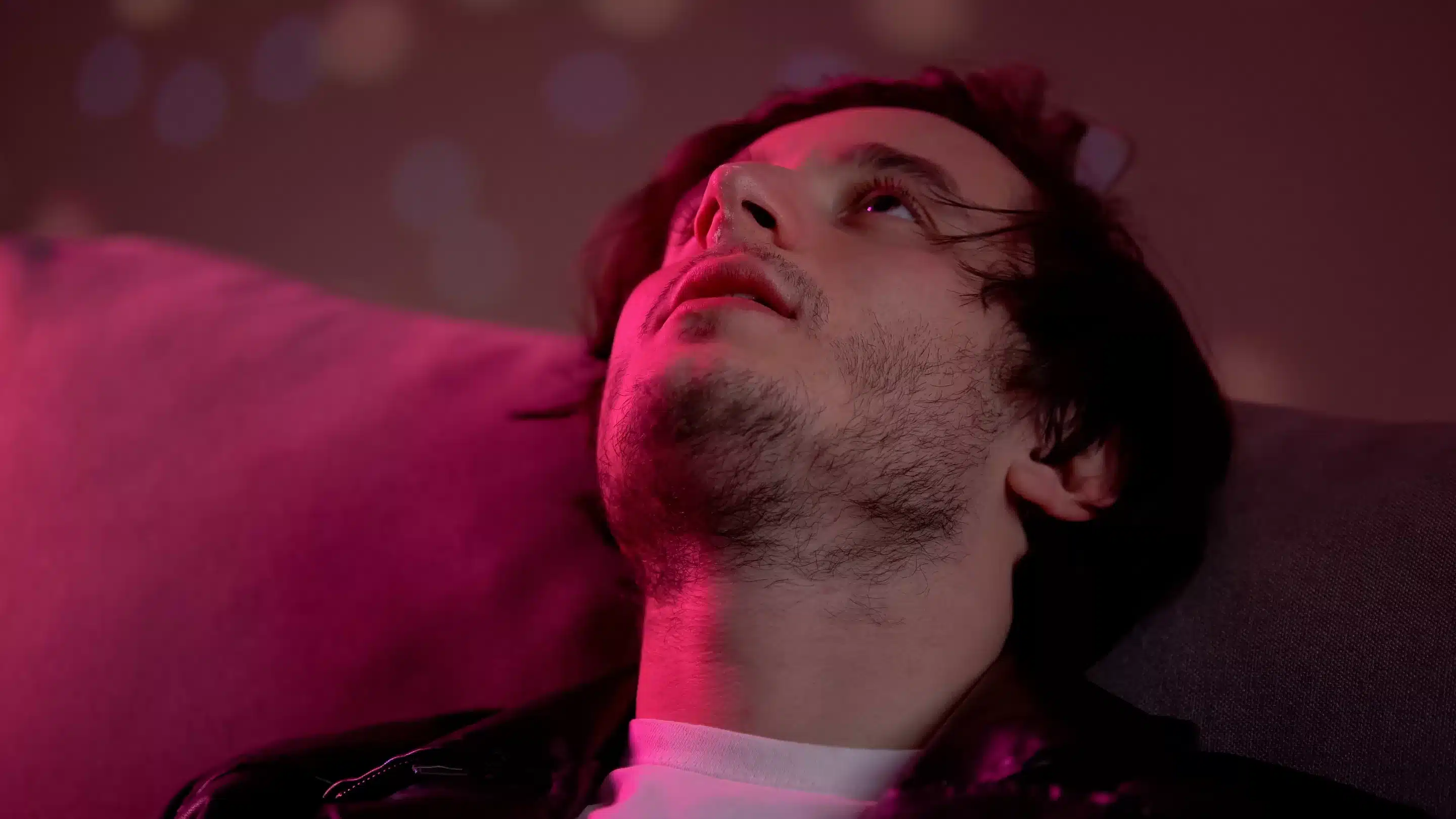 a man looking up with his eyes closed