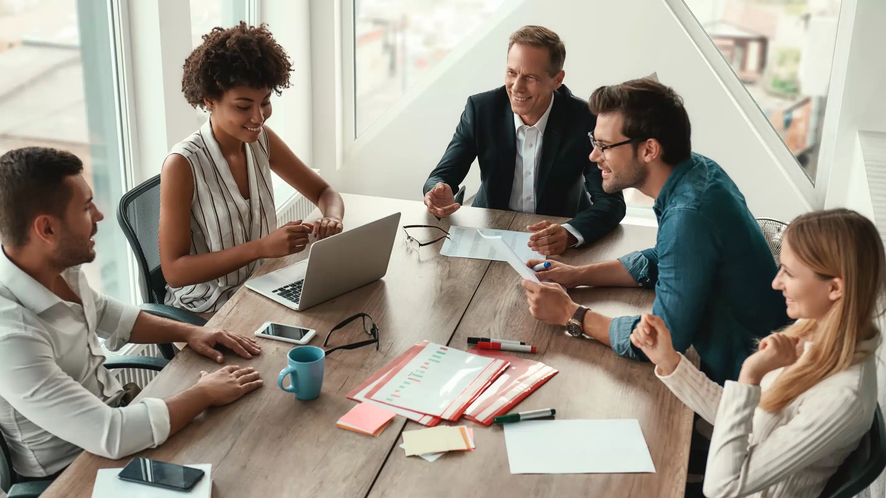 What is the difference between IOP and PHP? a group of people sitting around a table