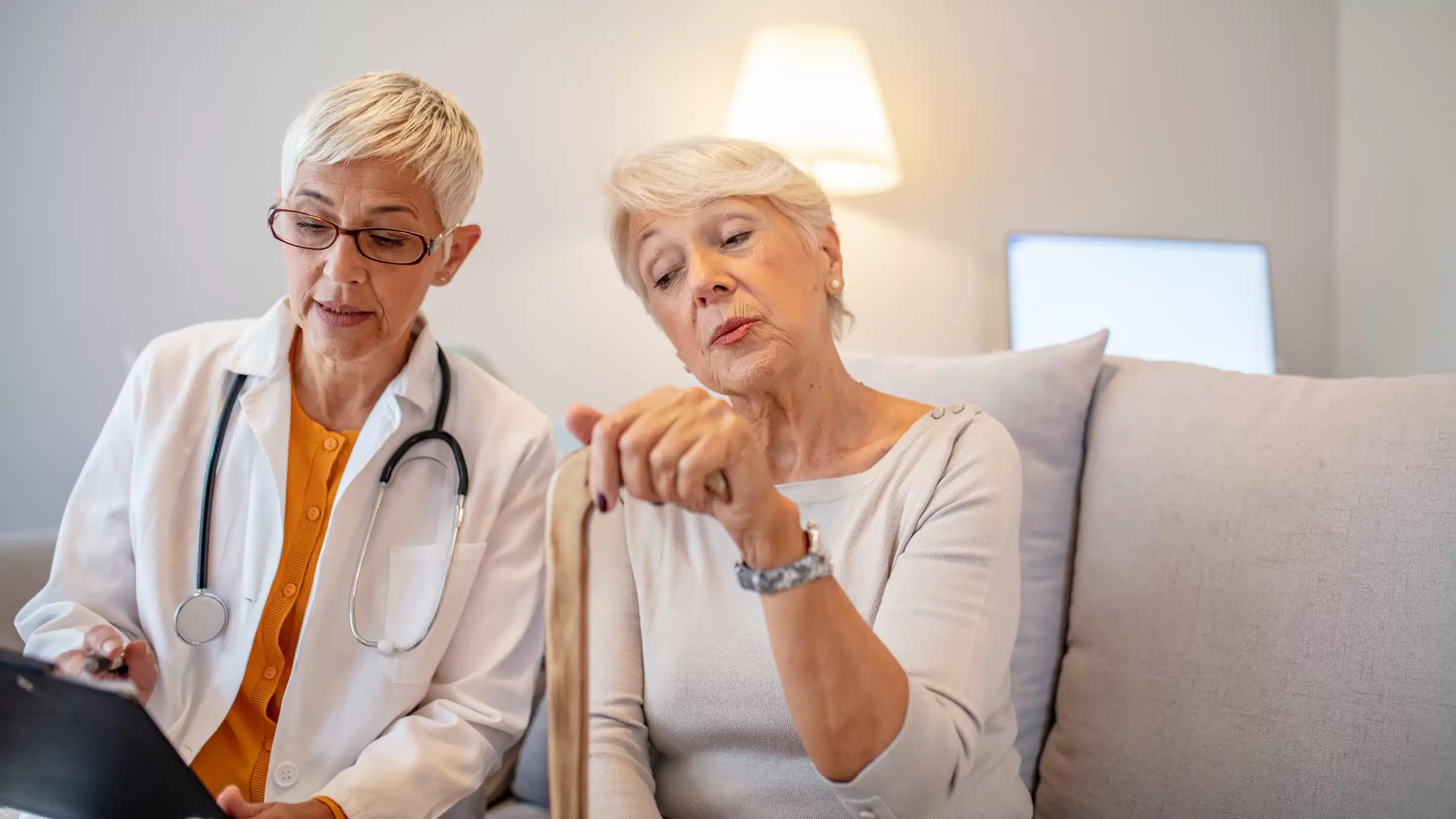 a woman holding a cane and a doctor