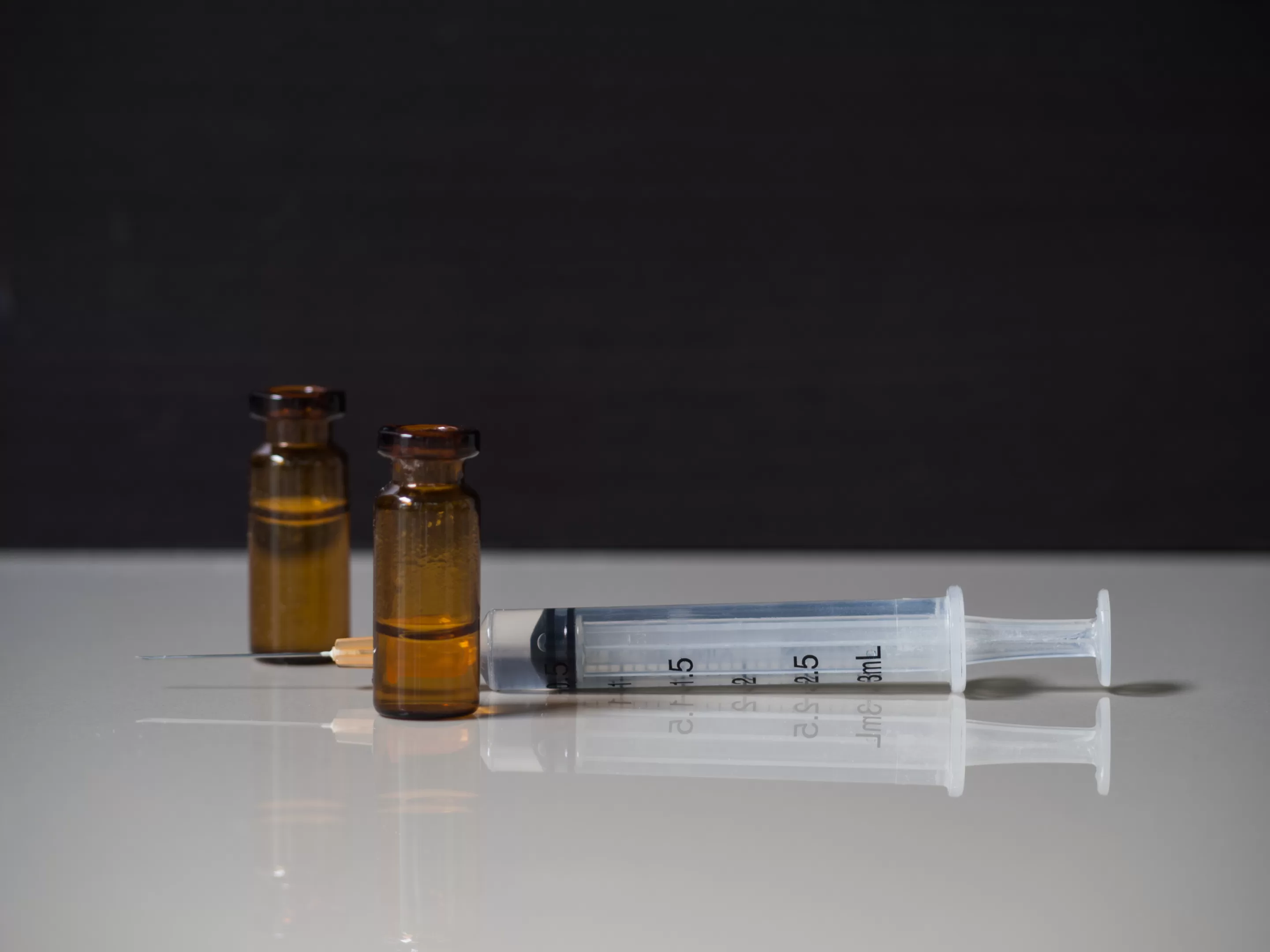 Ketamine in Syringe on Logo on White Floor,Speed Drug Education