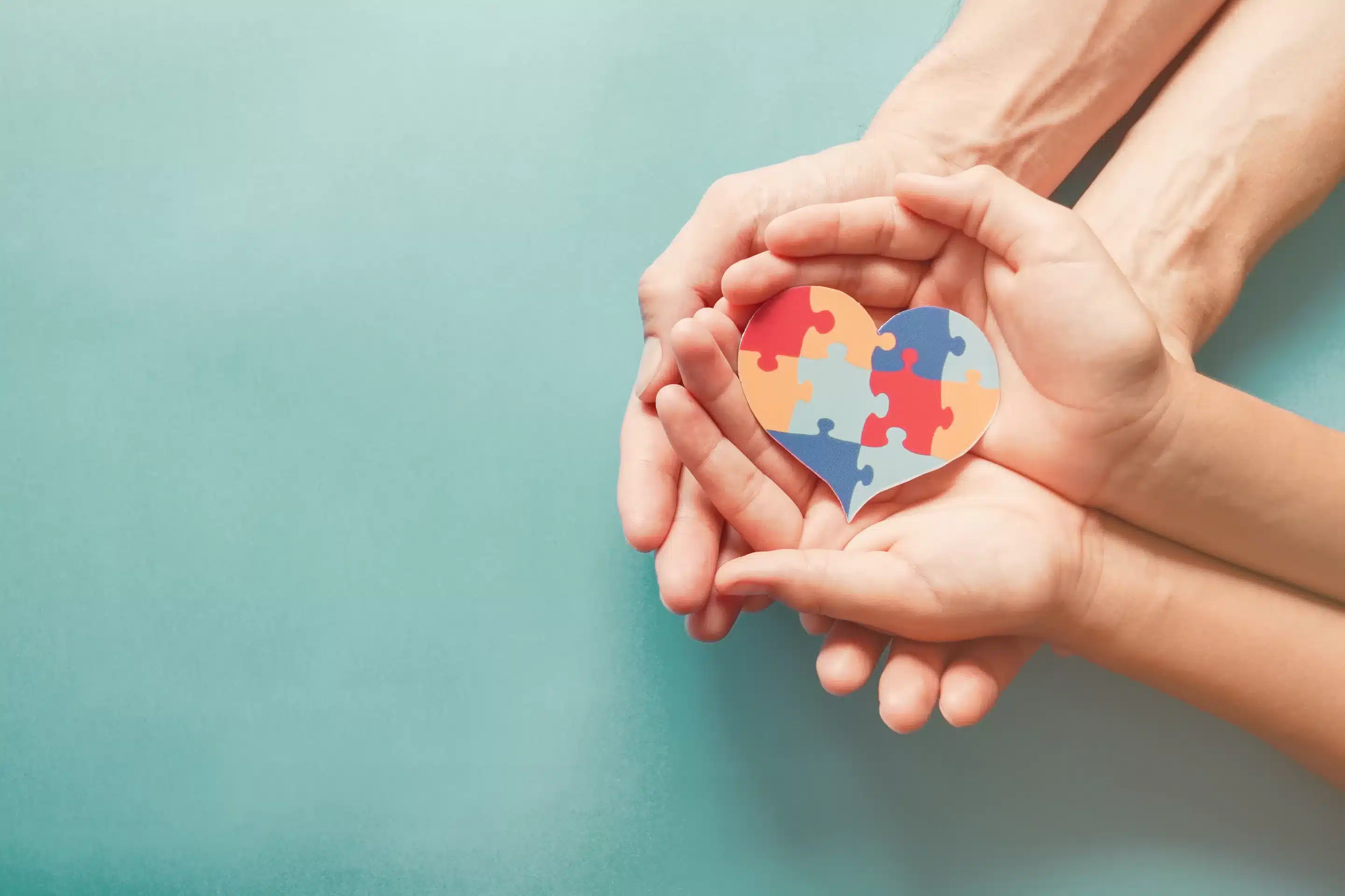 How society shapes diagnoses hands holding a puzzle piece in a heart shape
