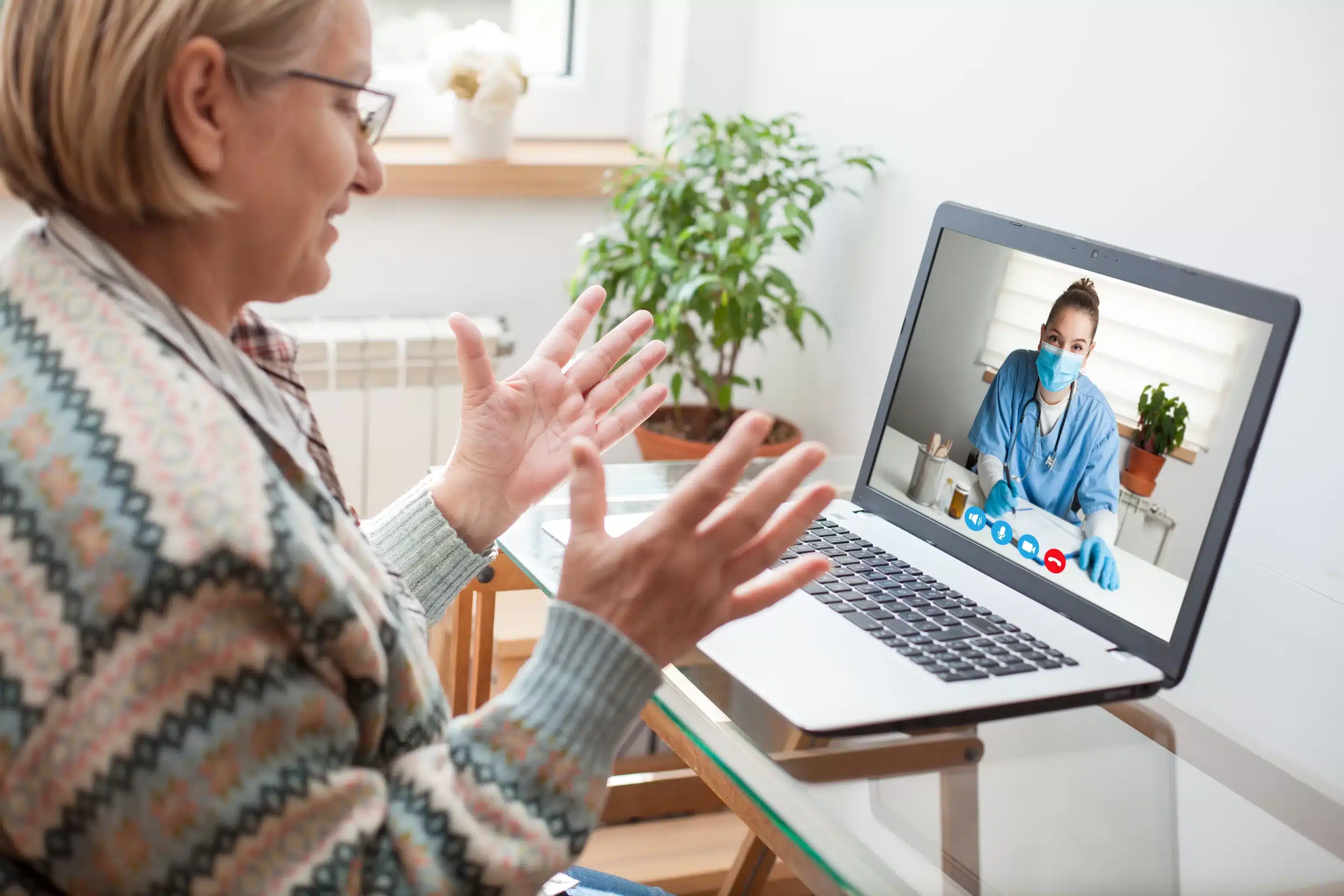 person sitting while using laptop computer and green stethoscope near