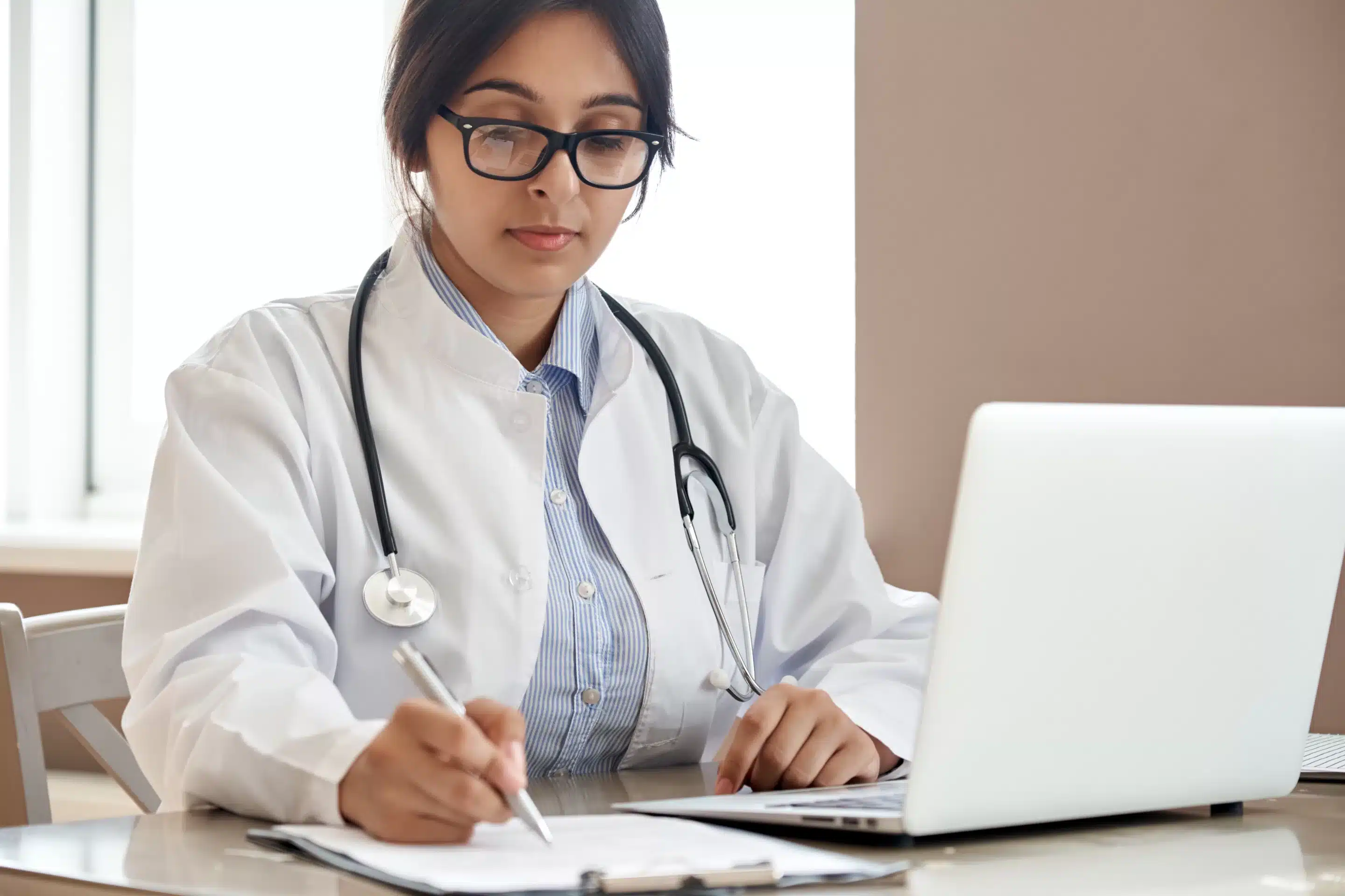 Indian ethnic female doctor physician gp wearing glasses,