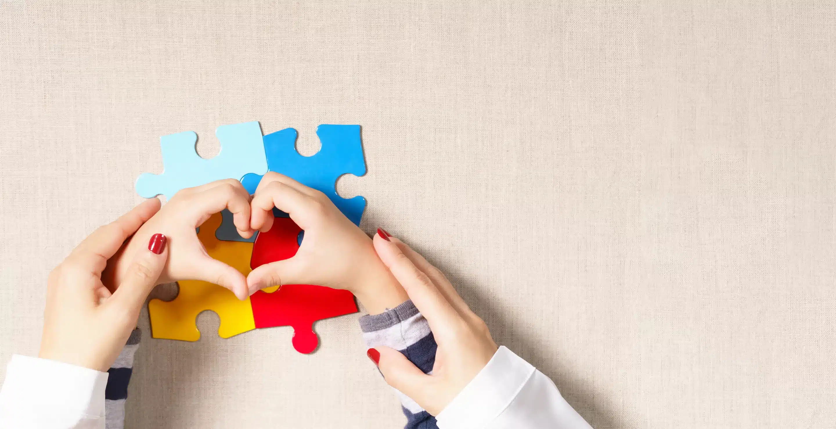 How society shapes diagnoses a hands making a heart with a puzzle piece