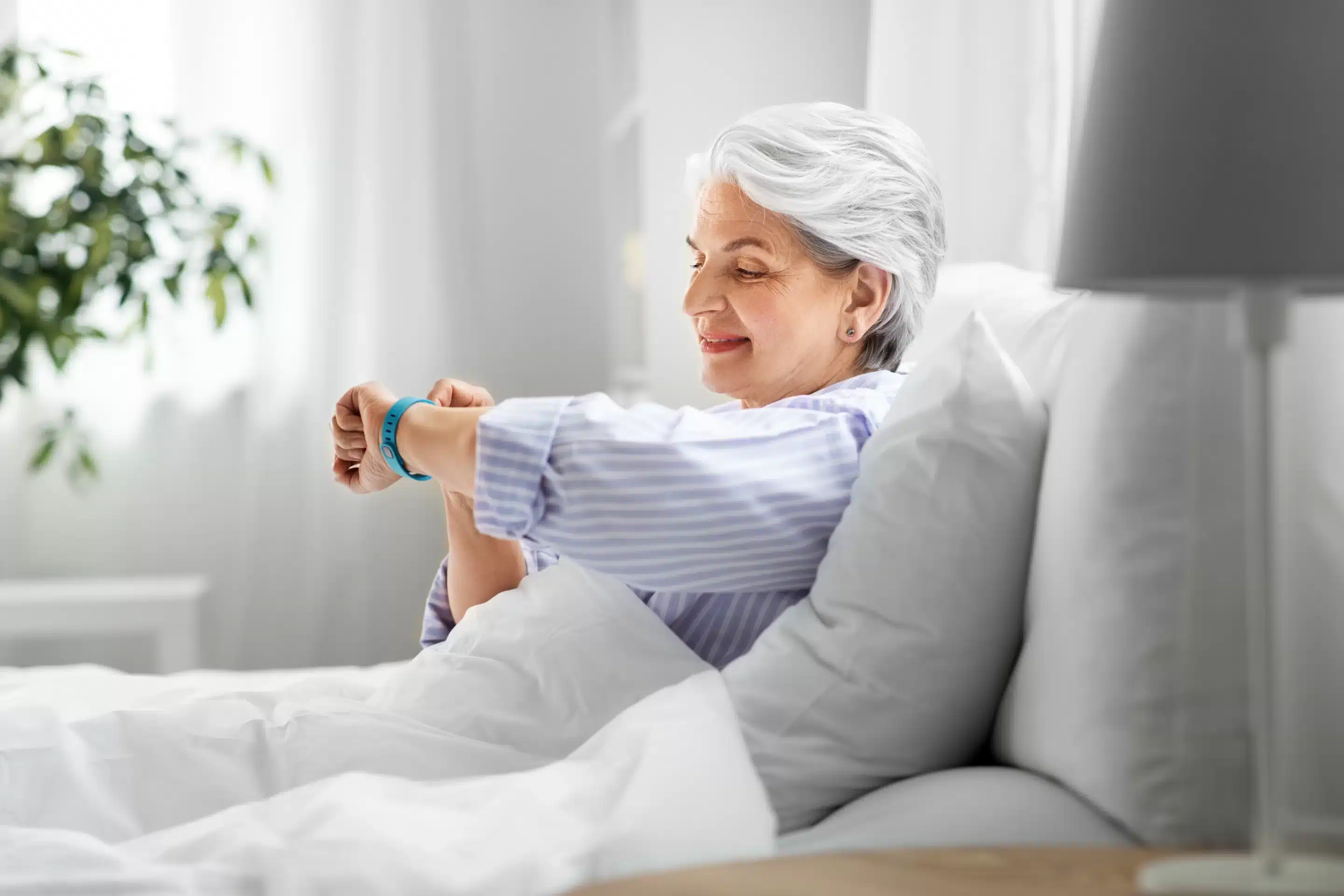 old age and people concept - happy smiling senior woman in pajamas