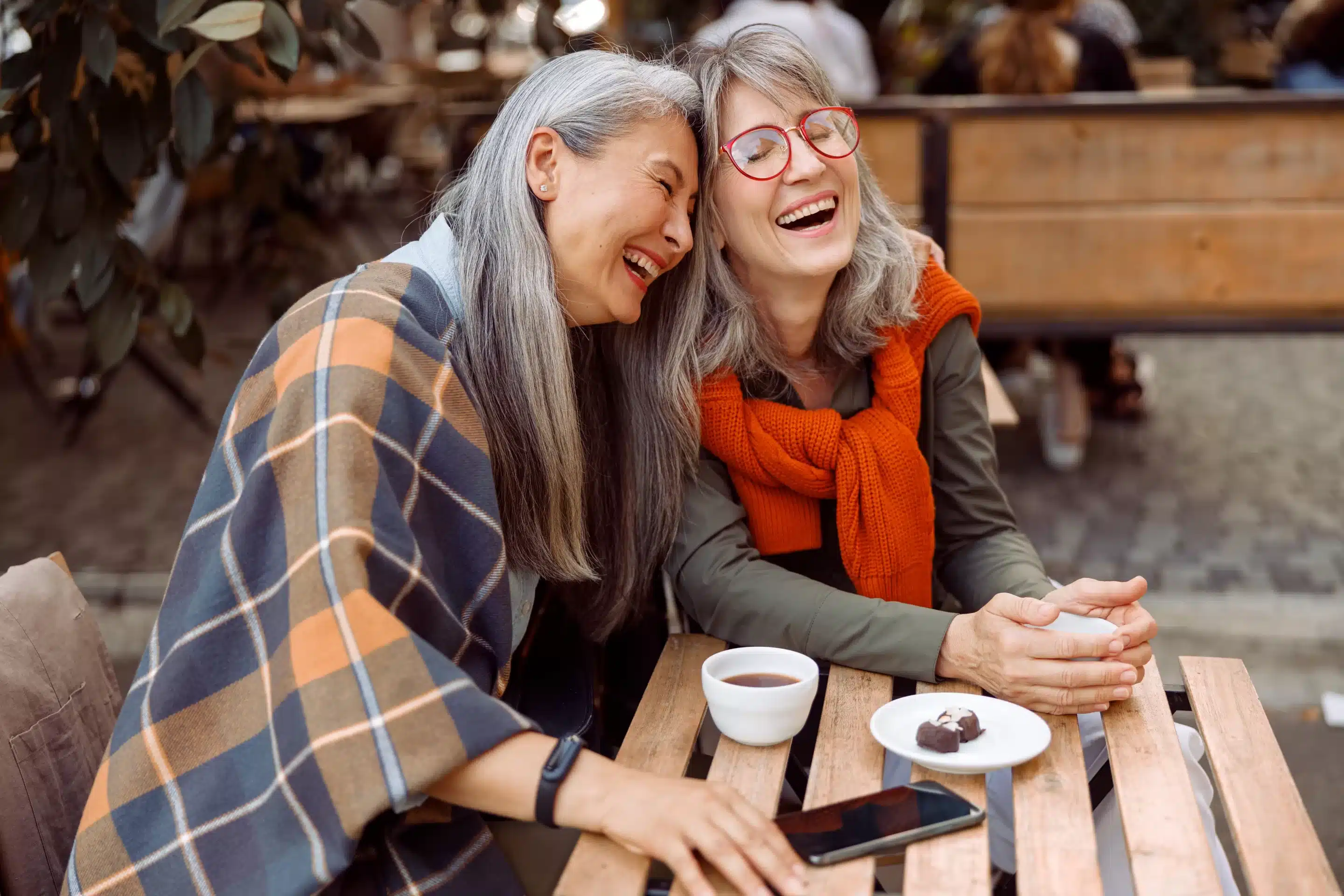 a woman rests her head on another person's shoulder