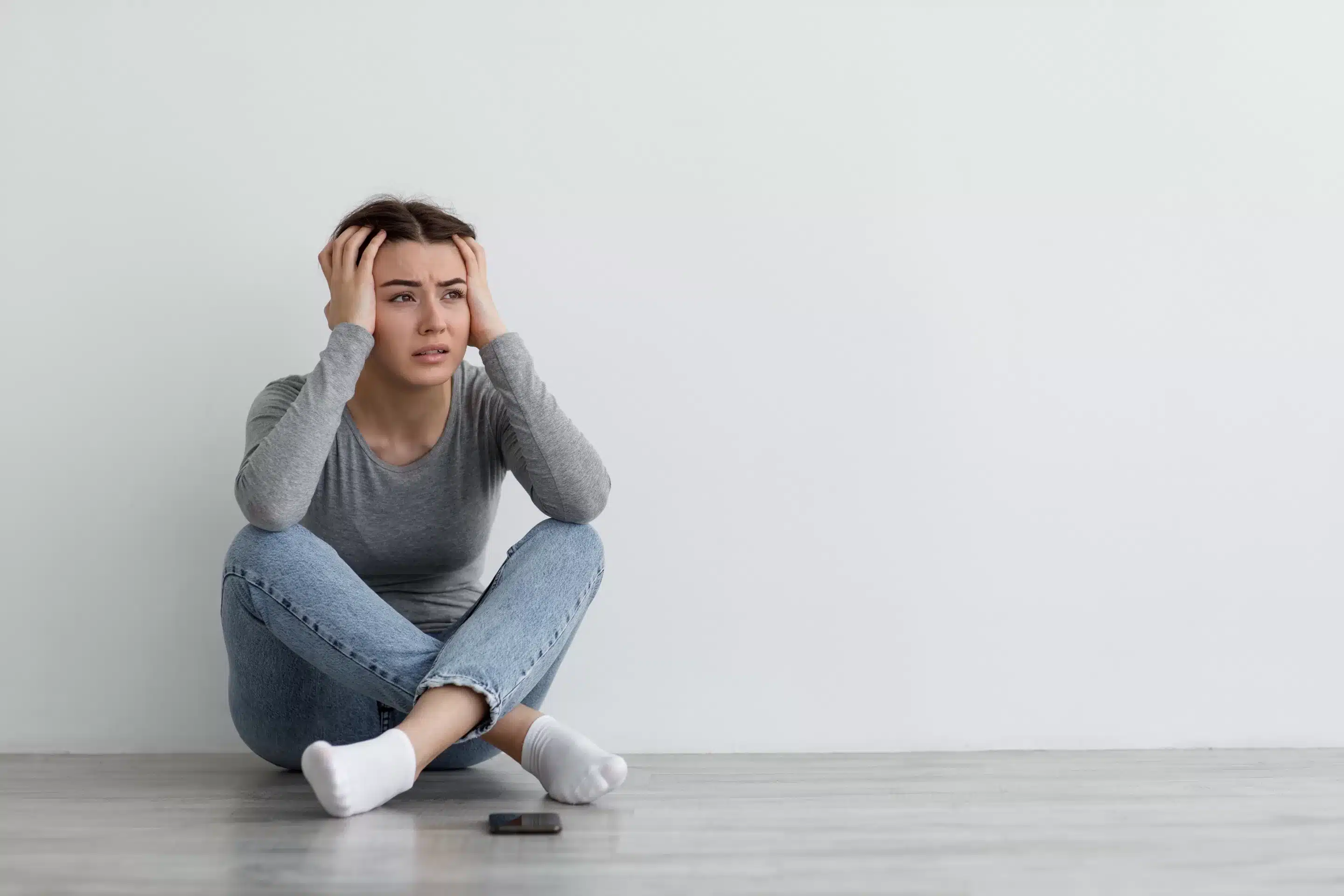 Despair anxious caucasian millennial lady sit on floor, suffering from depression,