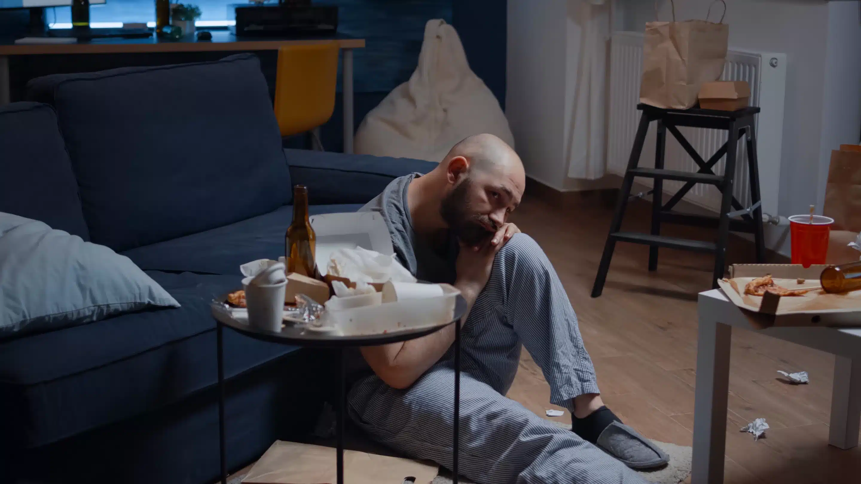 Depressed, disappointed, frustrated, ill man sitting on floor, feeling stressed,