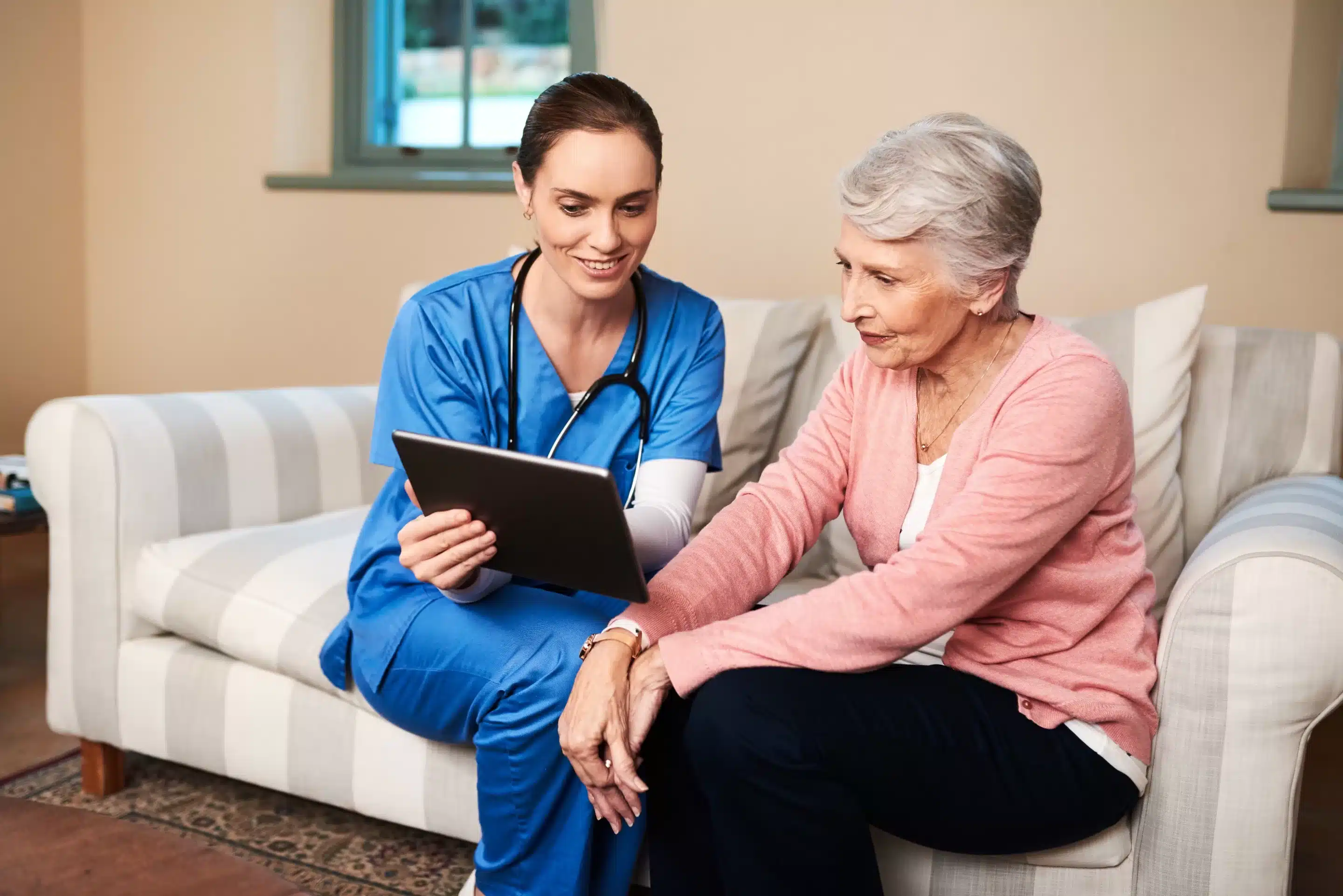 a woman and a doctor looking at a tablet