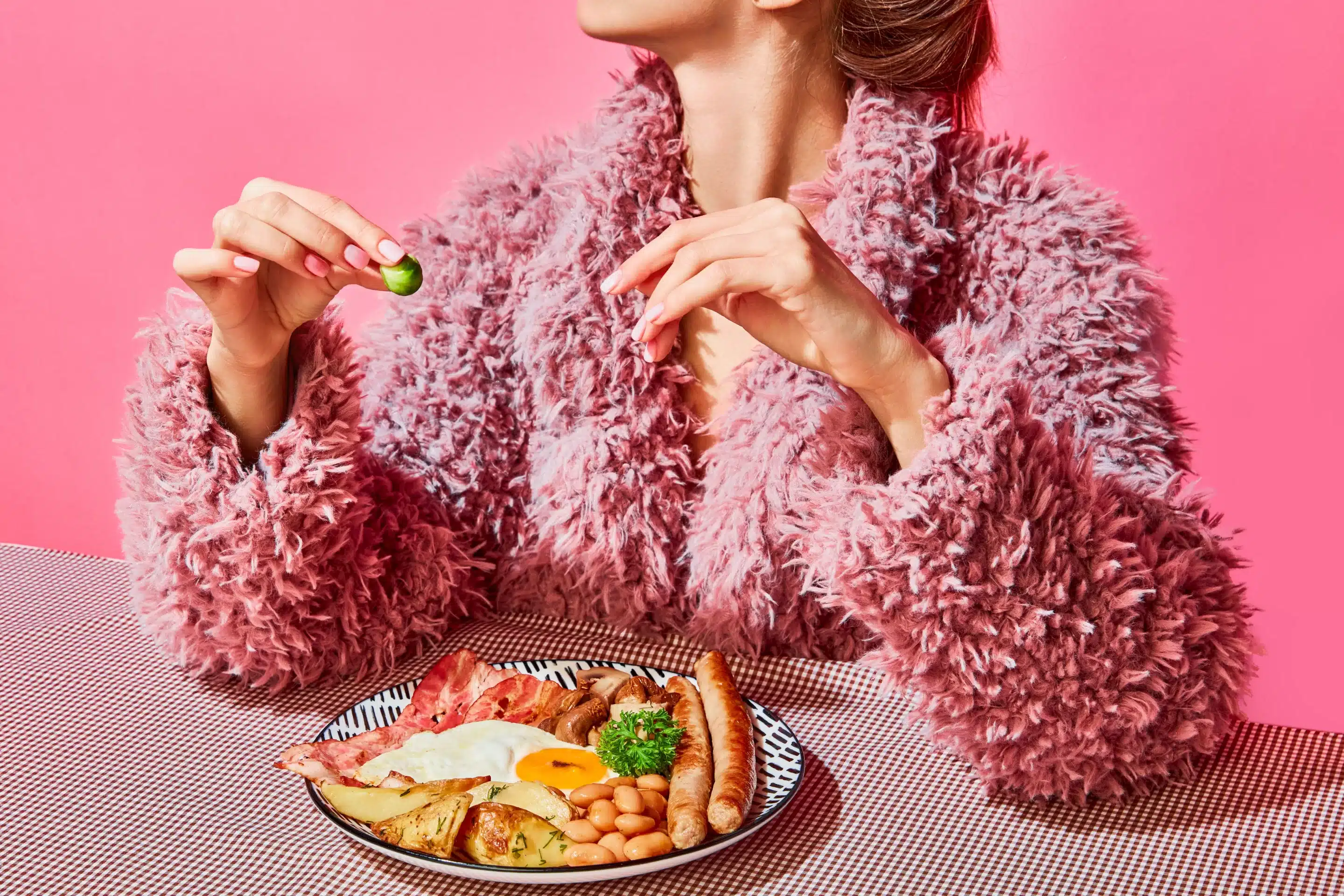 a woman sitting at a table with a plate of food