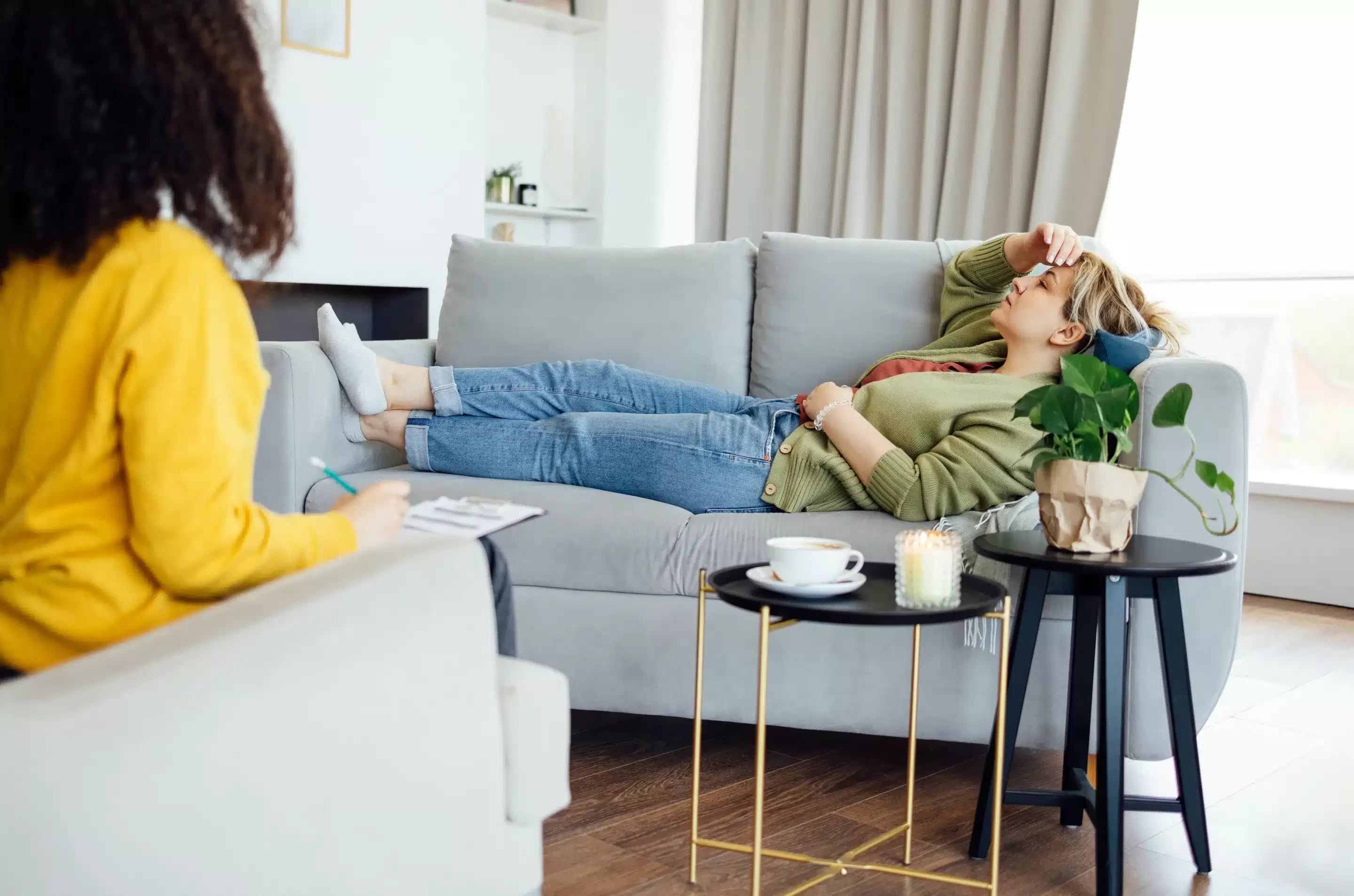a woman lying on a couch with her feet up