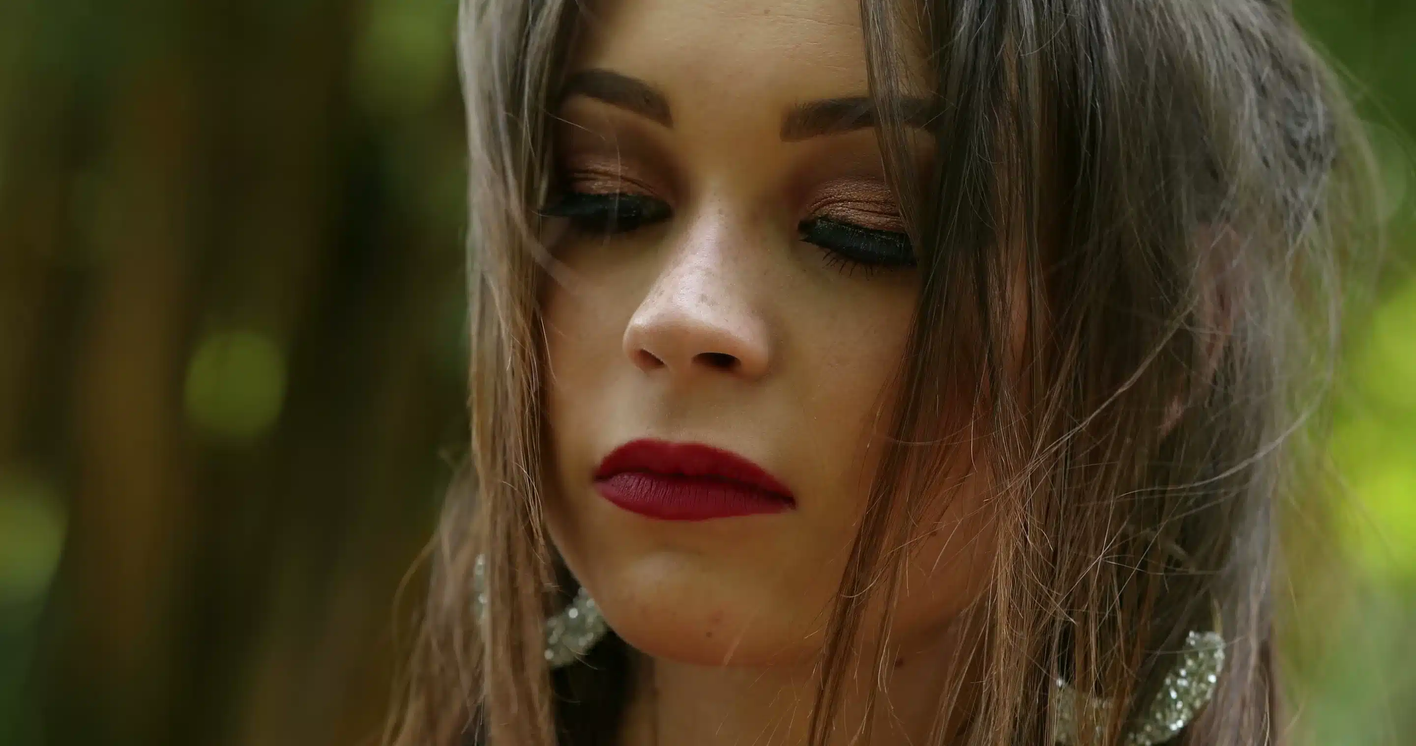 a woman with long hair and red lipstick