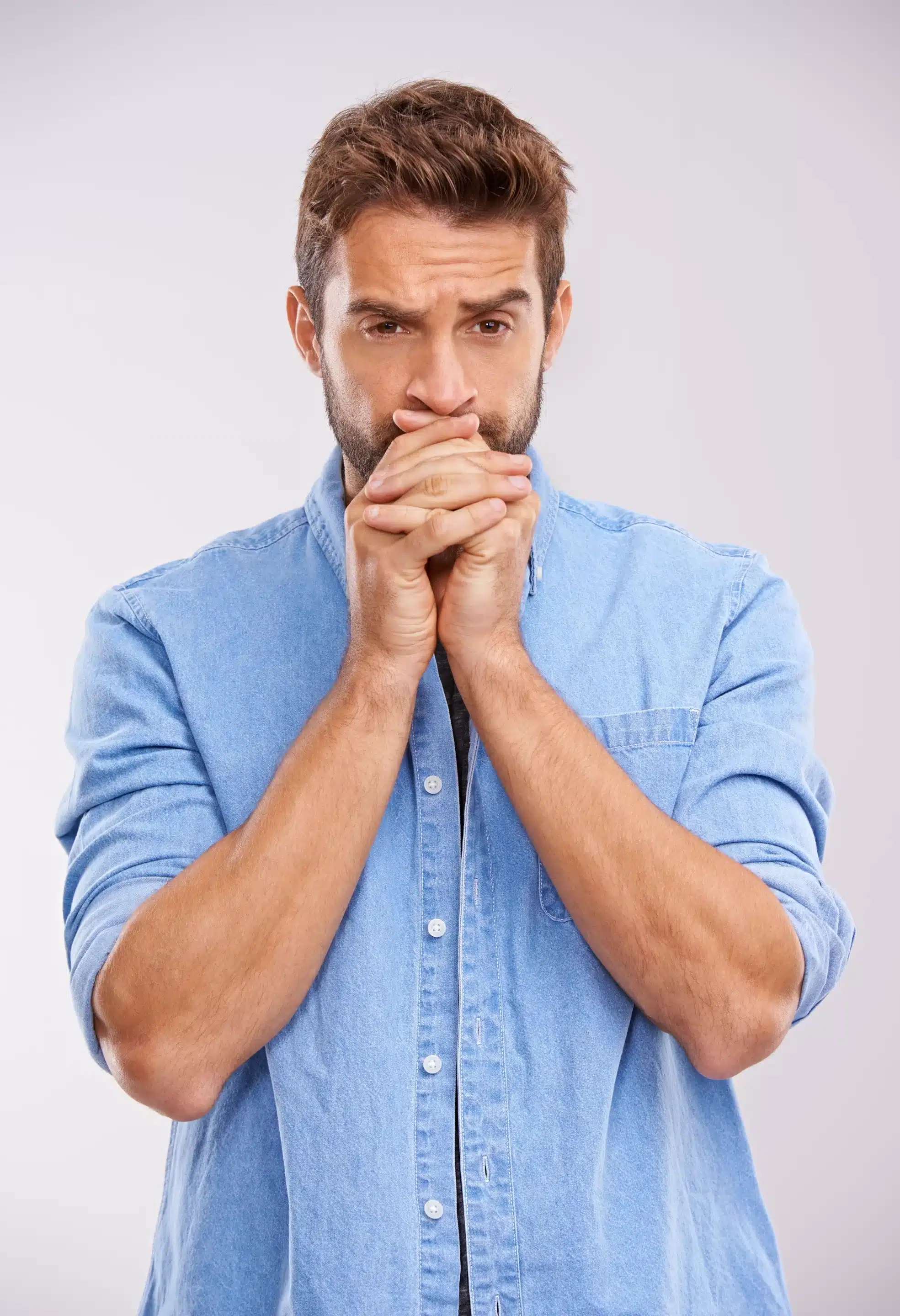 a man with his hands in his mouth