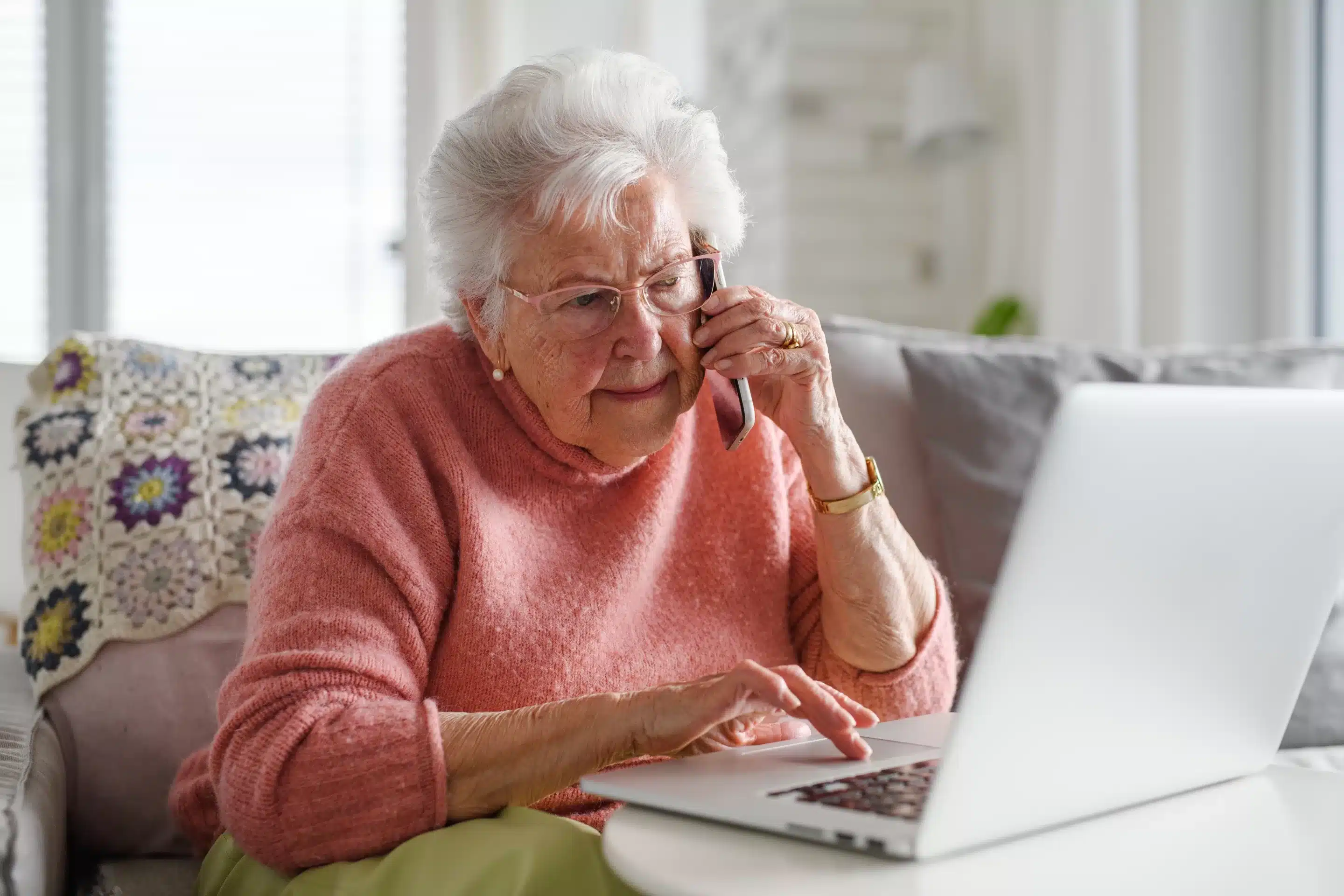 Senior woman working with laptop, shopping online, making cal