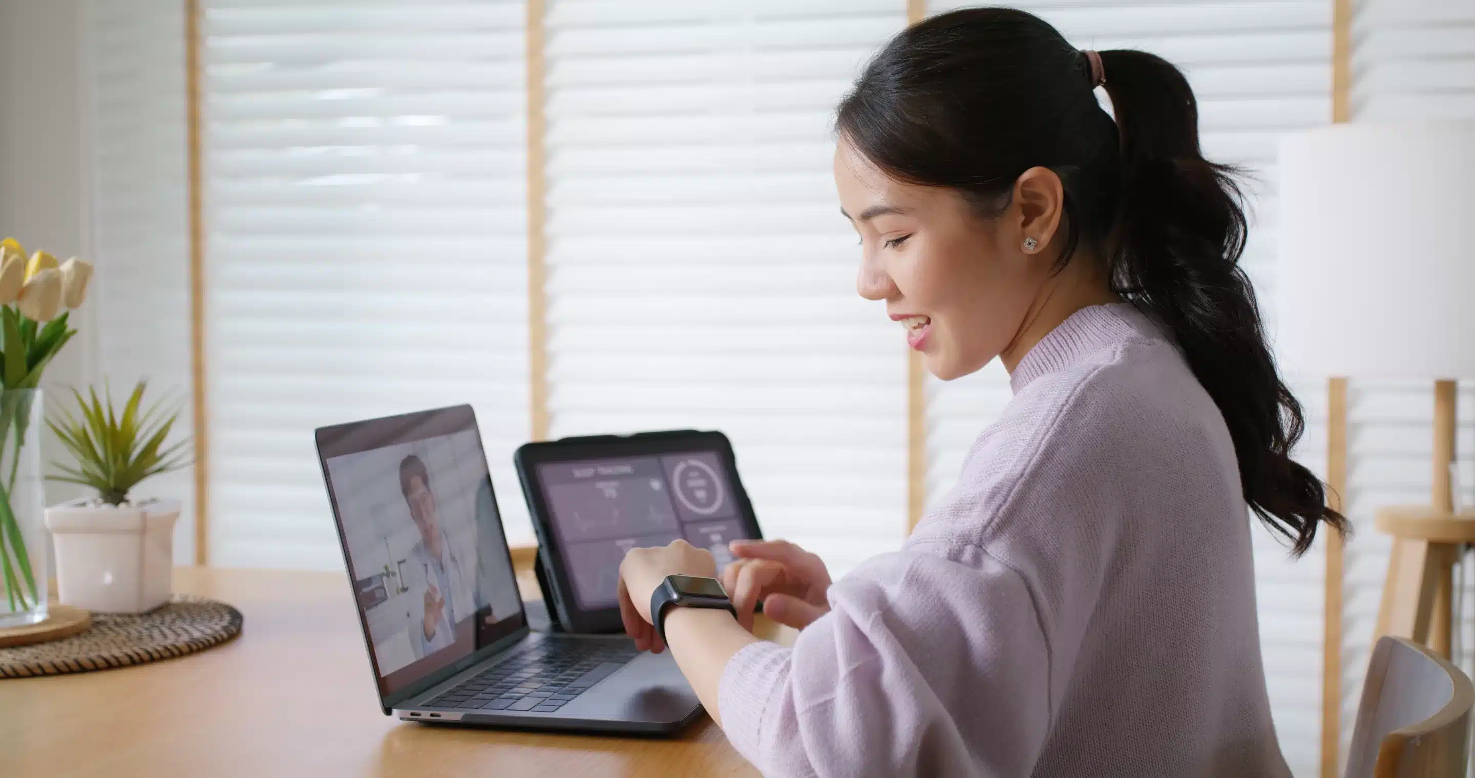 person sitting while using laptop computer and green stethoscope near