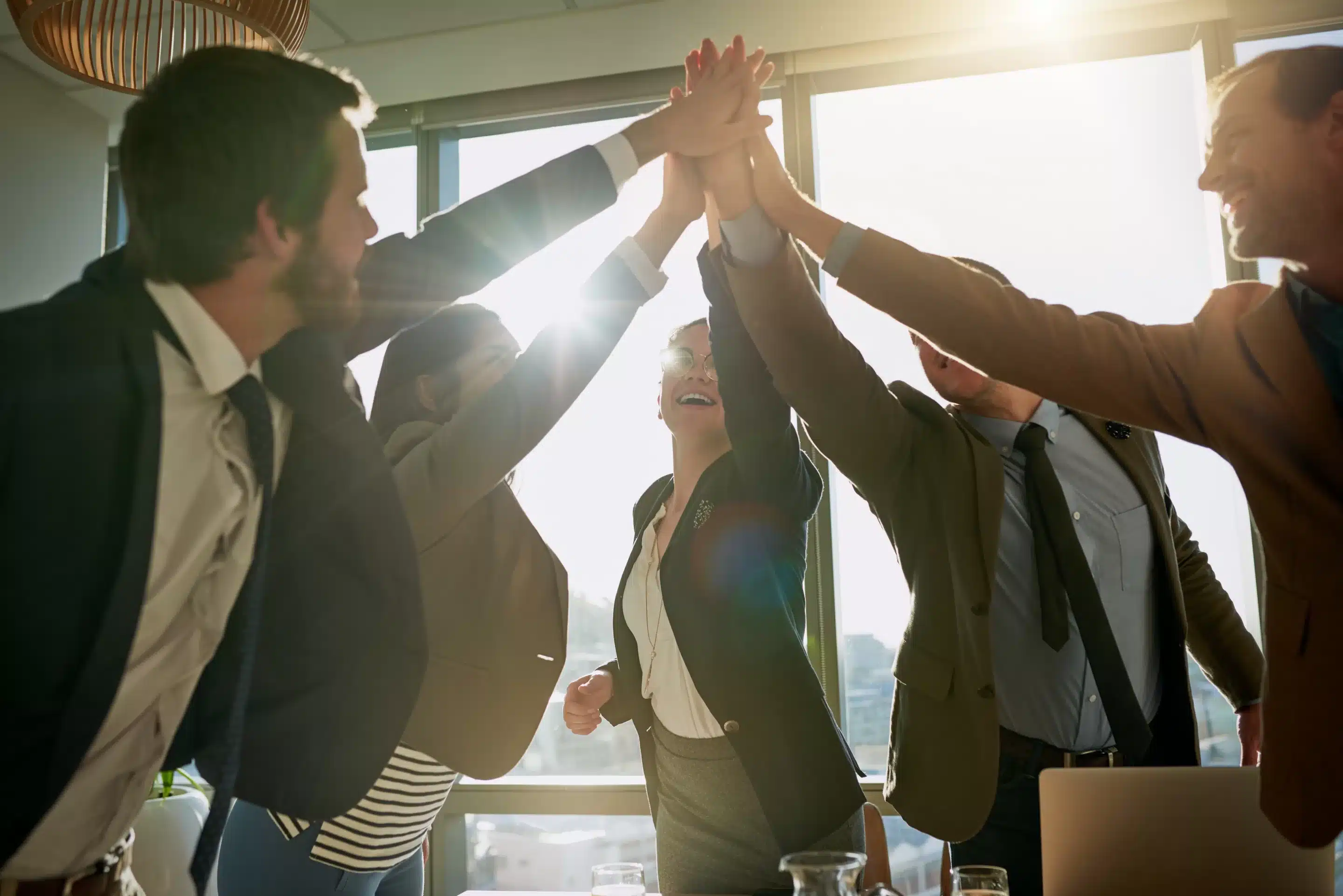 a group of people giving each other a high five