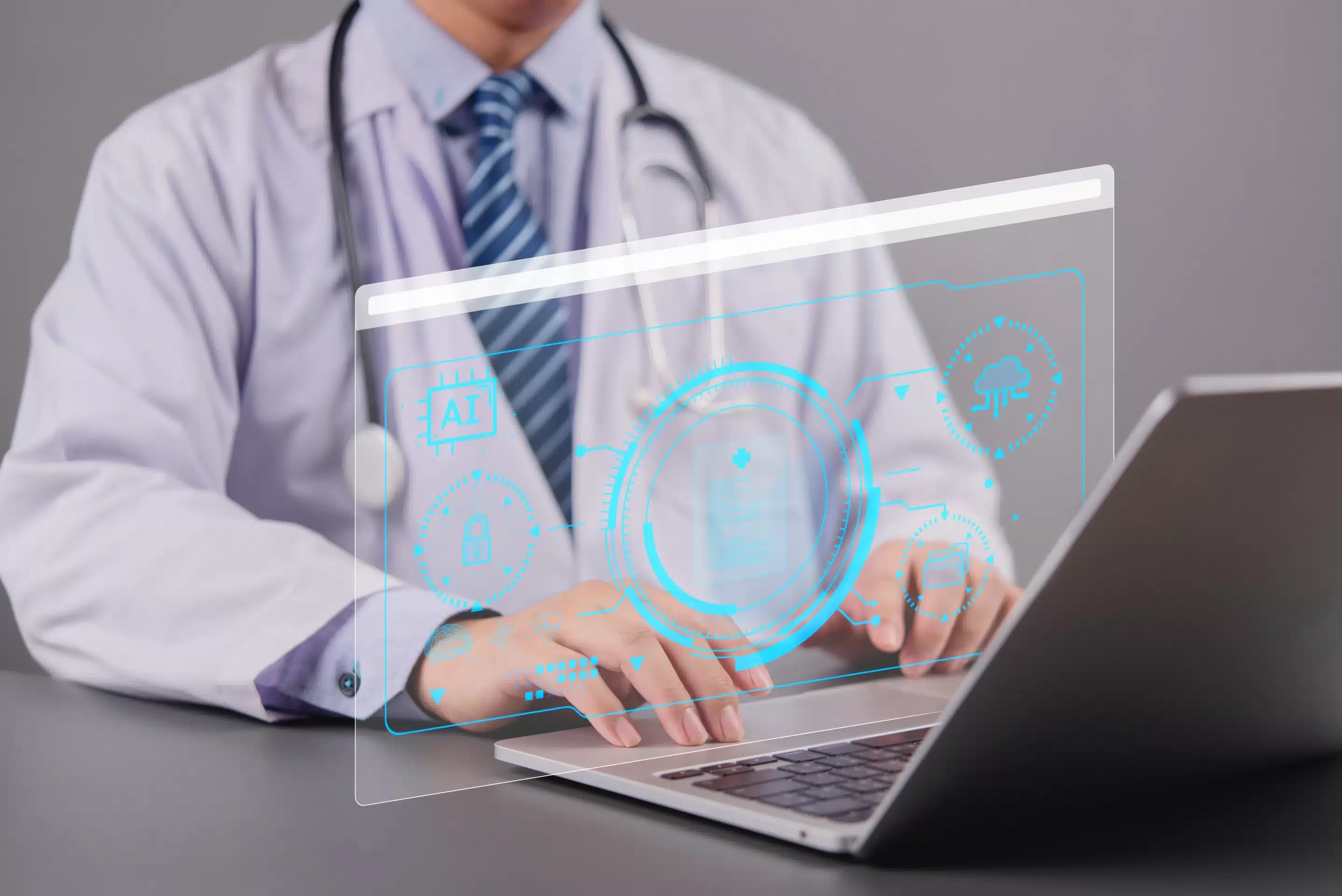 person sitting while using laptop computer and green stethoscope near