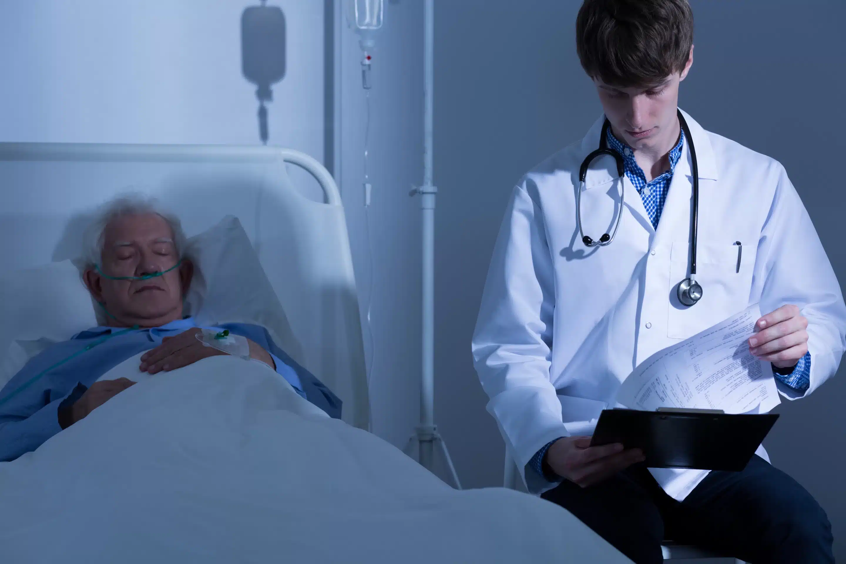 a doctor looking at an old woman lying in a hospital bed