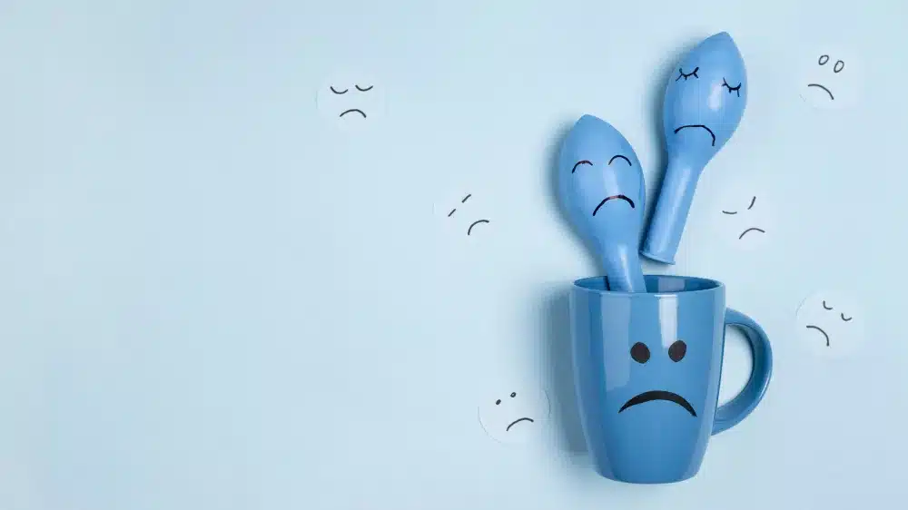 lonely blue cup with two lonely blue spoon