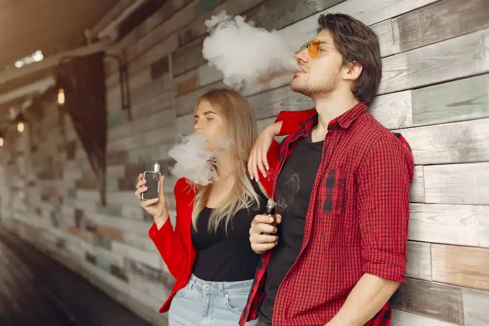 Man and woman vaping