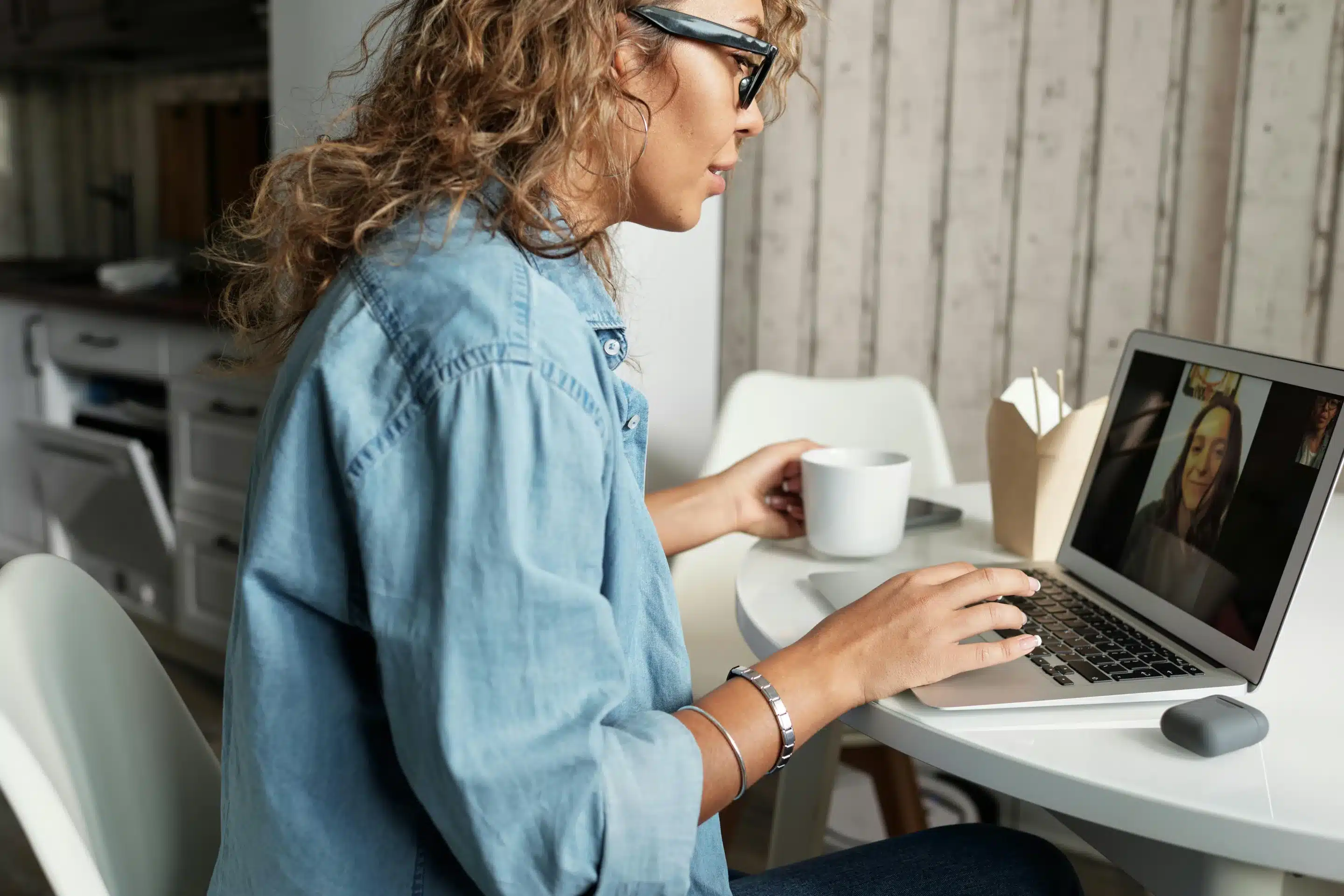 Woman speaking with another woman through a video call.