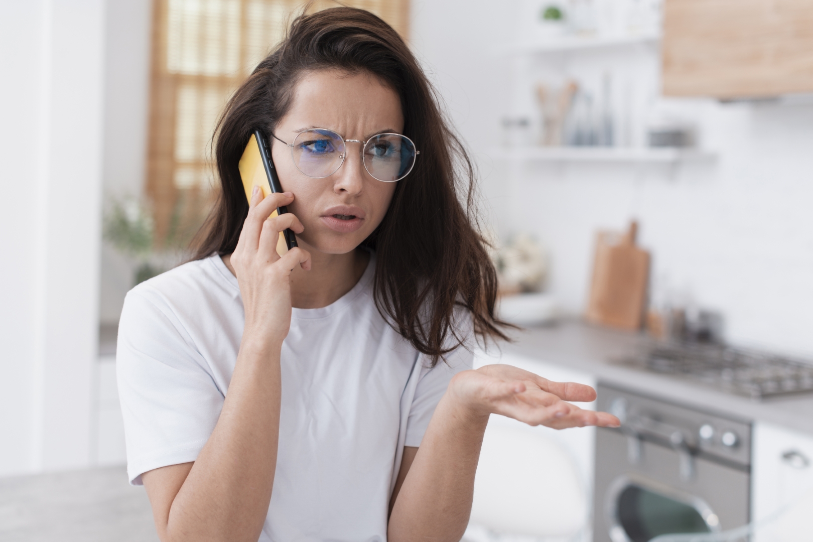 Frustrated woman angrily talking on her smartphone