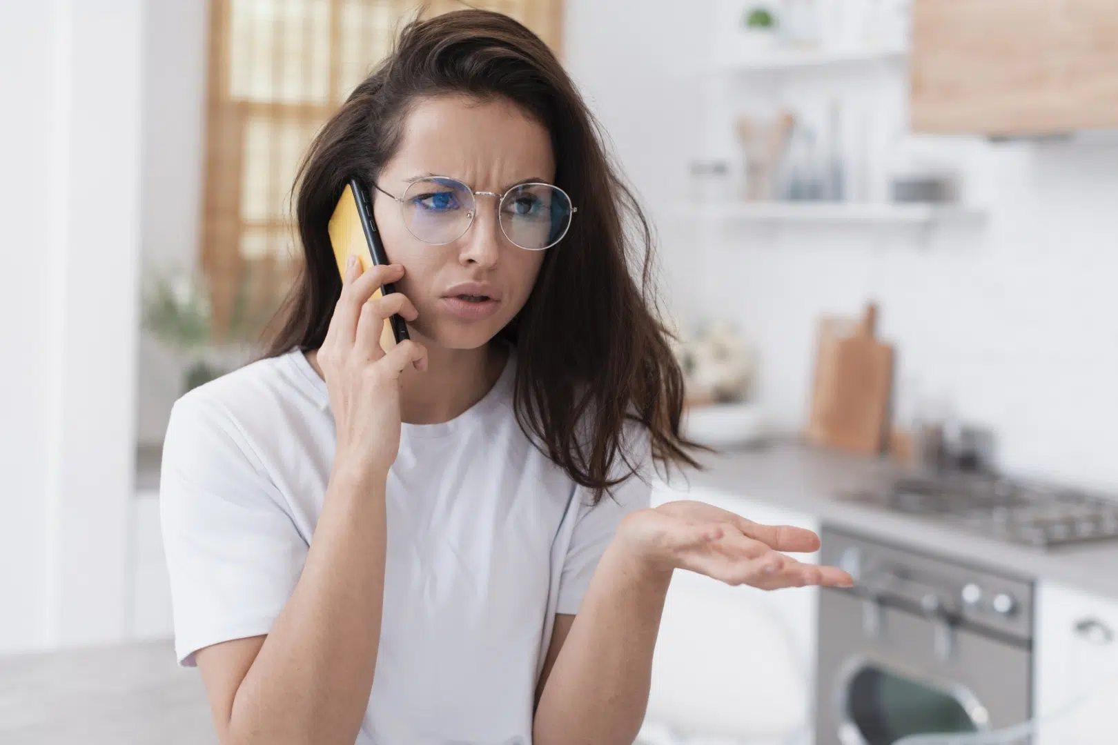 Frustrated woman angrily talking on her smartphone
