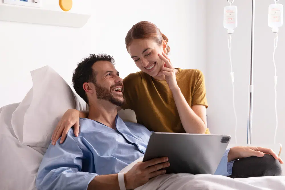 Happy married couple smiling together after successful medical treatment