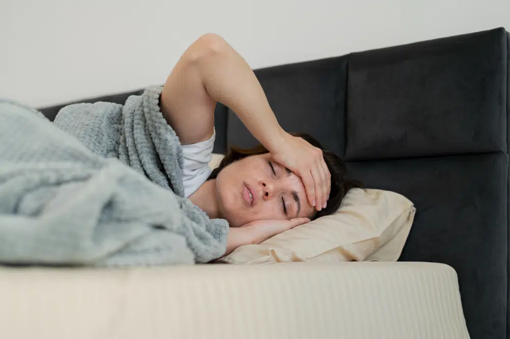 Sick woman resting in bed during illness - medium shot